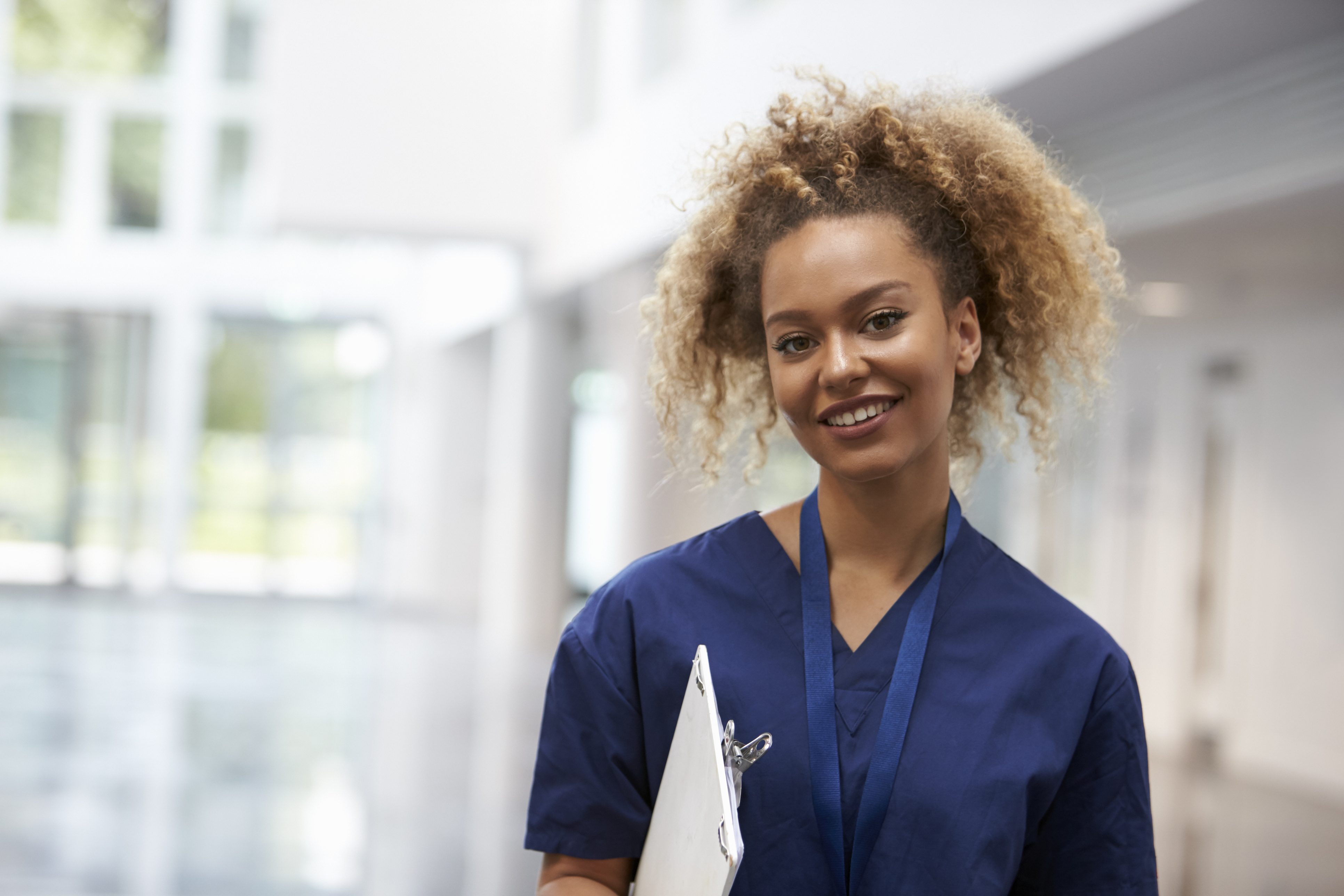 Portrait Of Female Nurse Wearing Scrubs In Hospital